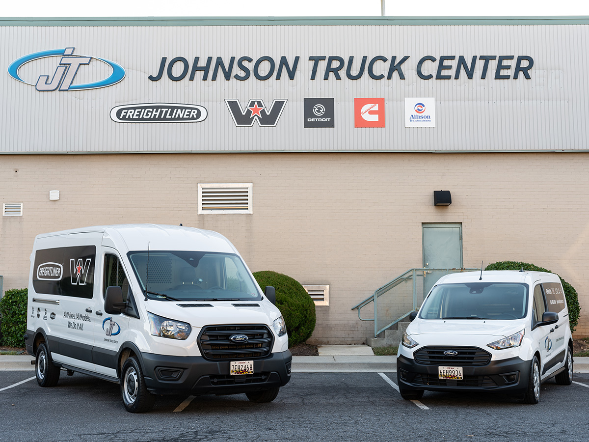 Photo of Johnson Truck Center delivery vans in front of JTC building